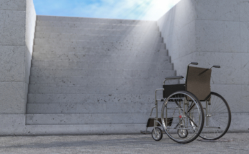 Empty Wheelchair in Front of Concrete Stairs extreme closeup